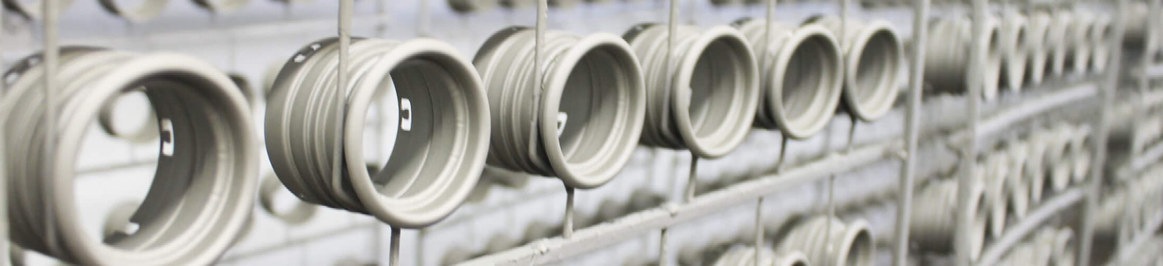 manufacturing facility exterior photo with rows of metal pipes in perspective