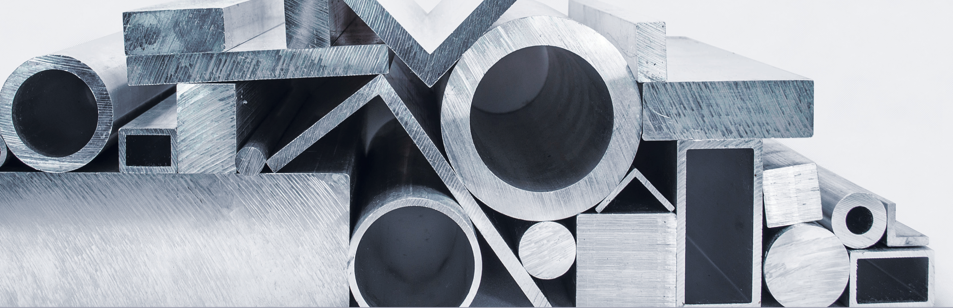black and white photo of stacked metal rods and blocks in a manufacturing facility