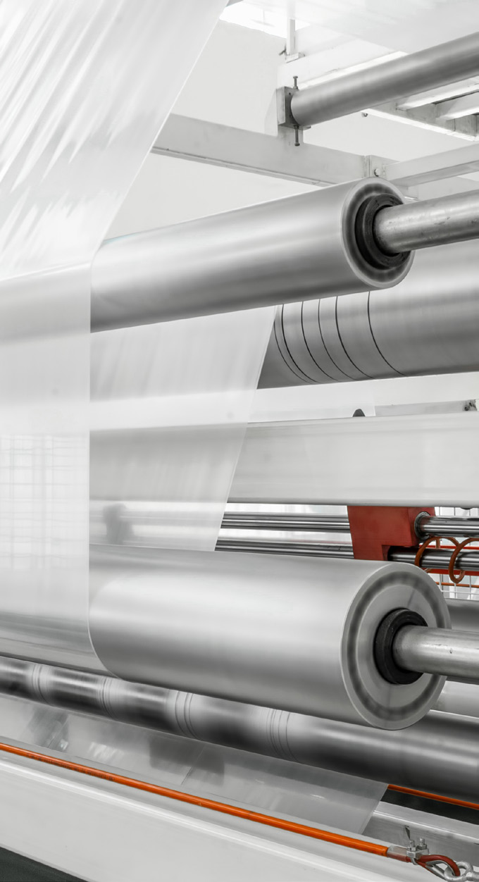 industrial machinery with rollers and metal components in a manufacturing facility