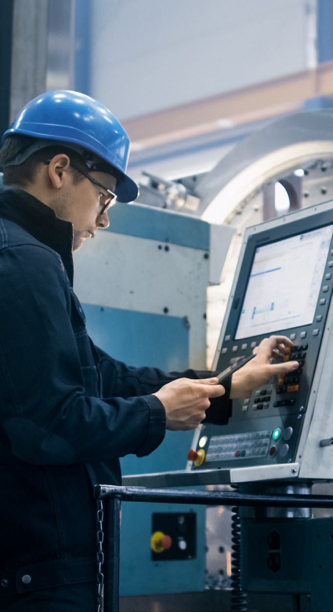 Worker operating production line in a manufacturing facility