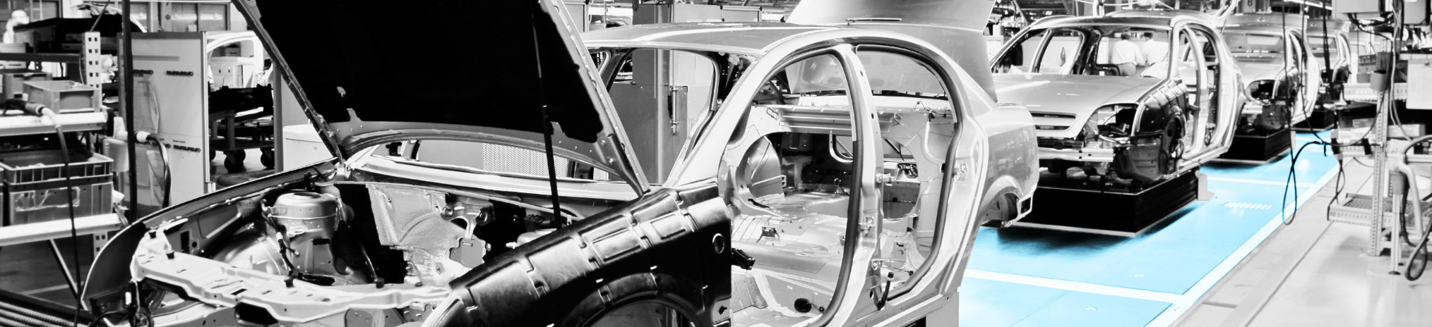 manufacturing facility interior with car assembly line and vehicles in production