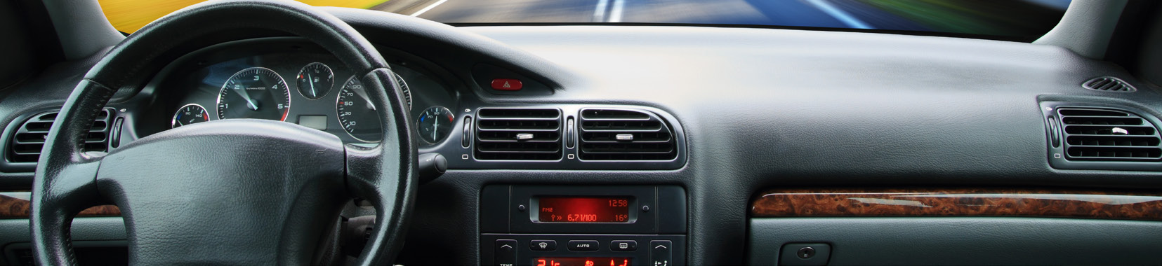 Interior view of a car dashboard and steering wheel with instrument panel