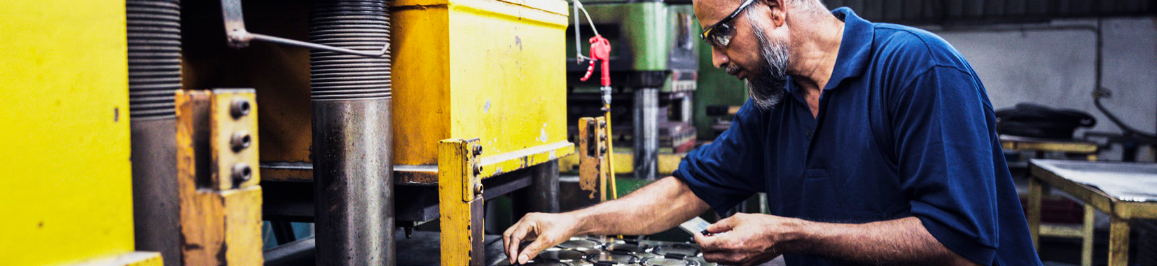 manufacturing facility interior with worker operating machinery