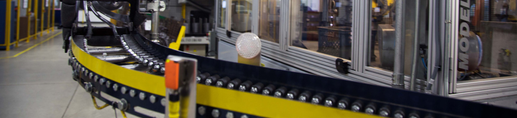 Manufacturing facility interior with conveyor belt and machinery