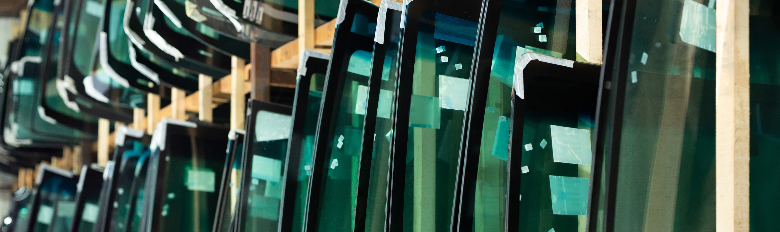 manufacturing facility interior with rows of green machinery and equipment
