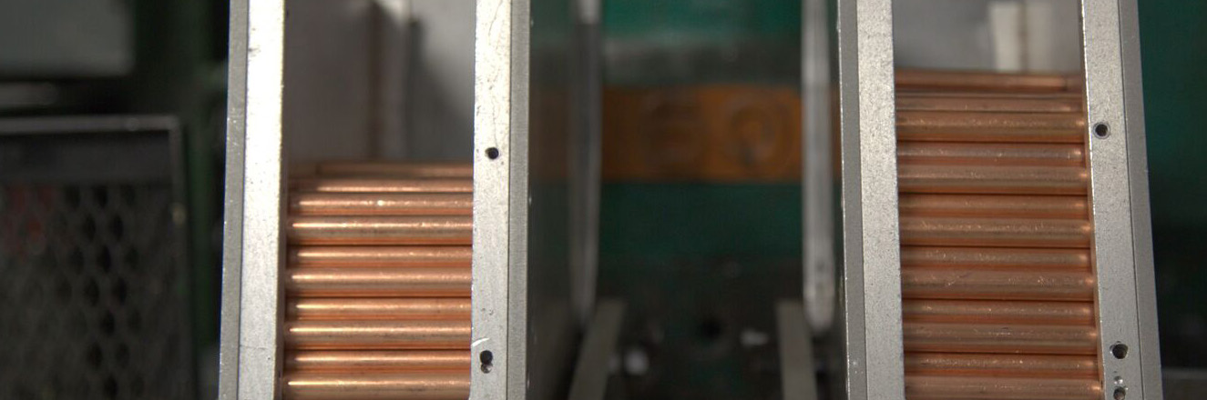 manufacturing facility interior photo with metal racks and copper coils
