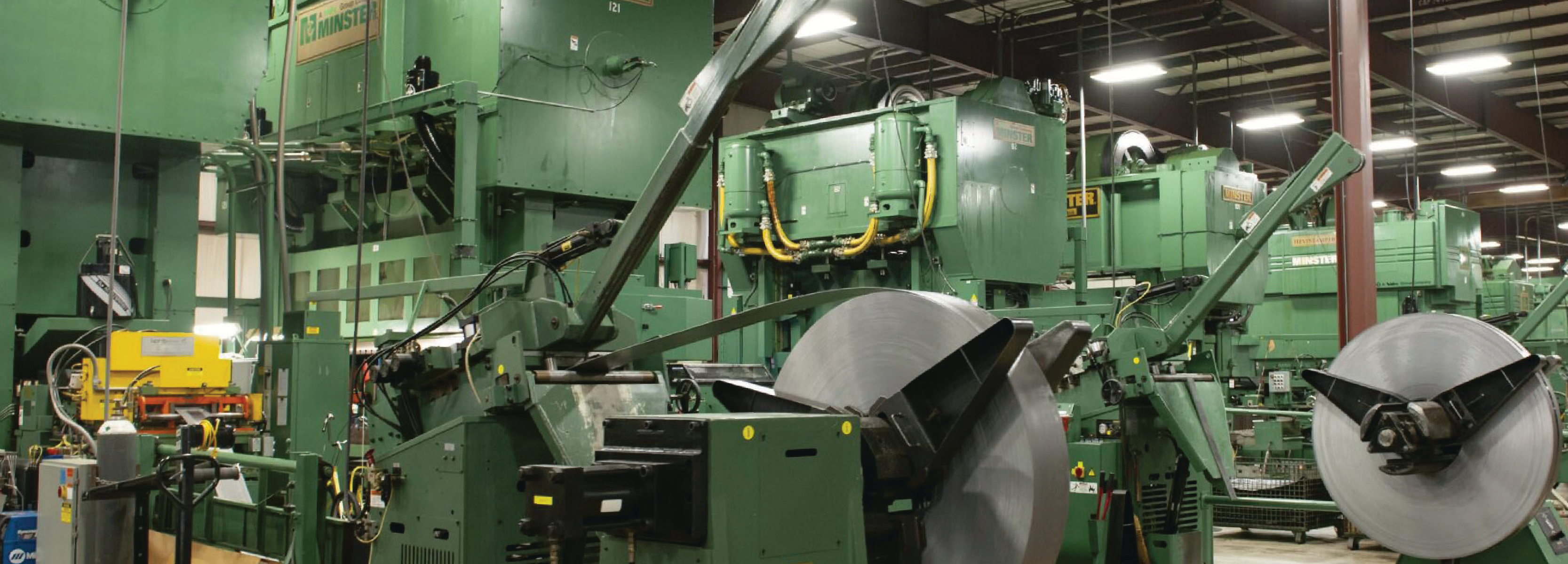manufacturing facility interior with large green industrial machines and equipment