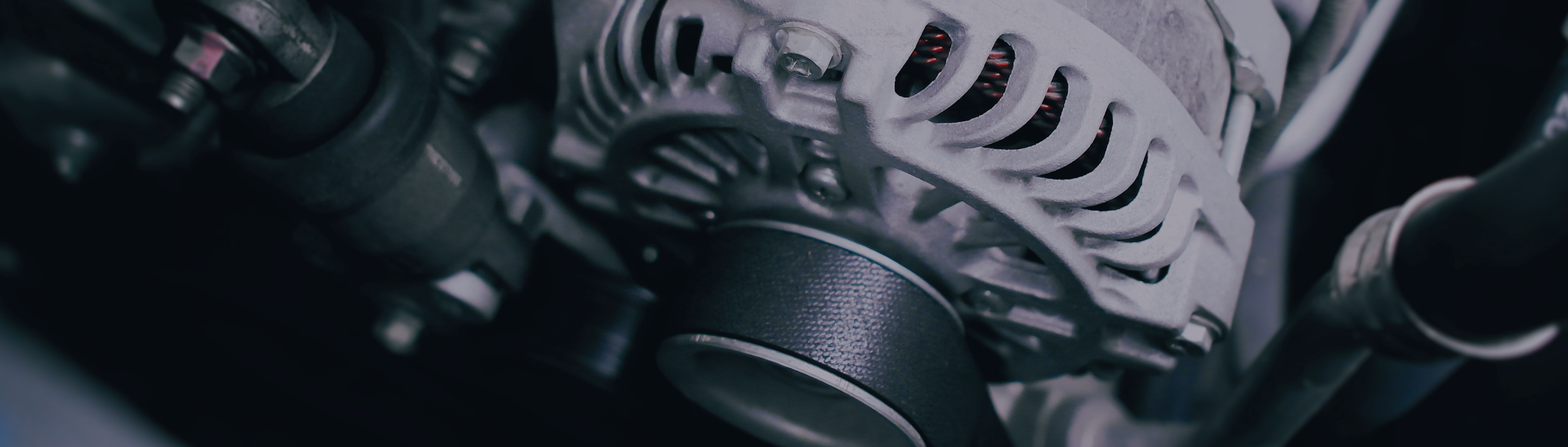 close-up photo of mechanical parts in a manufacturing facility with dark metal and black components