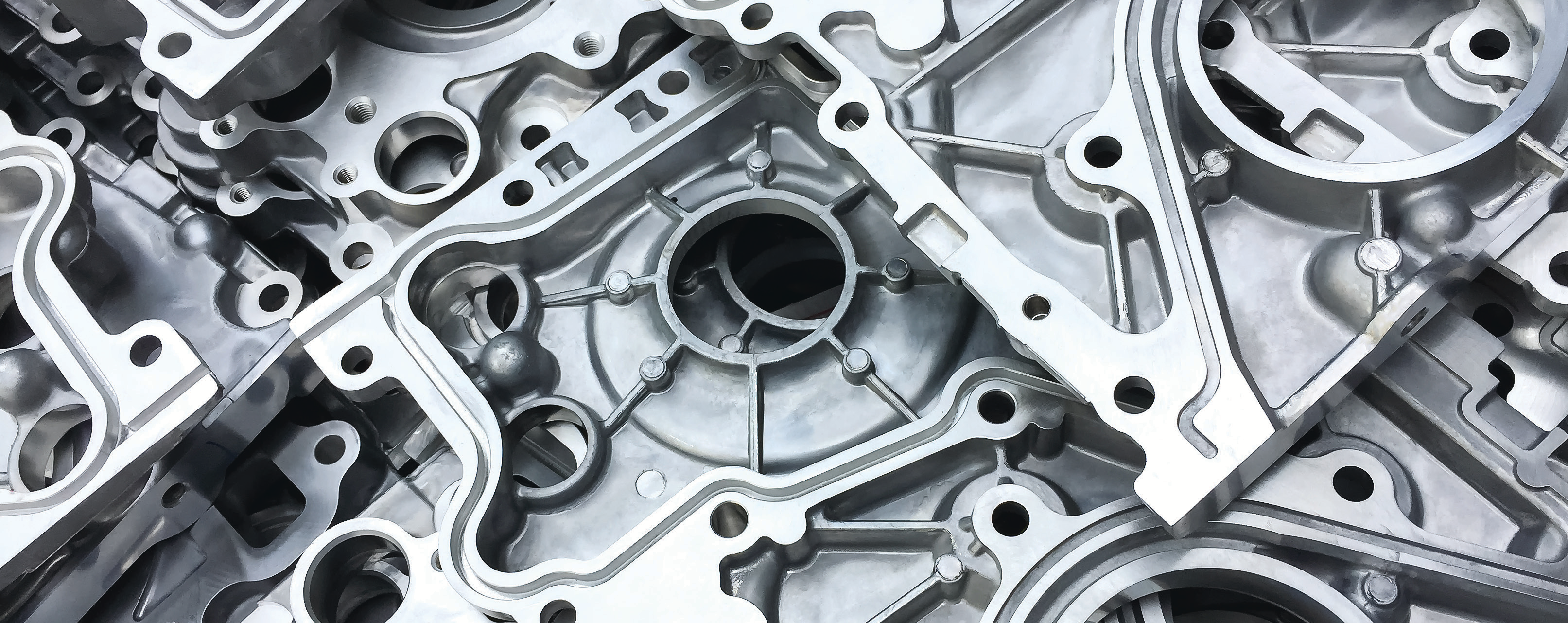 close-up photo of metal mechanical parts with bolts and circular holes