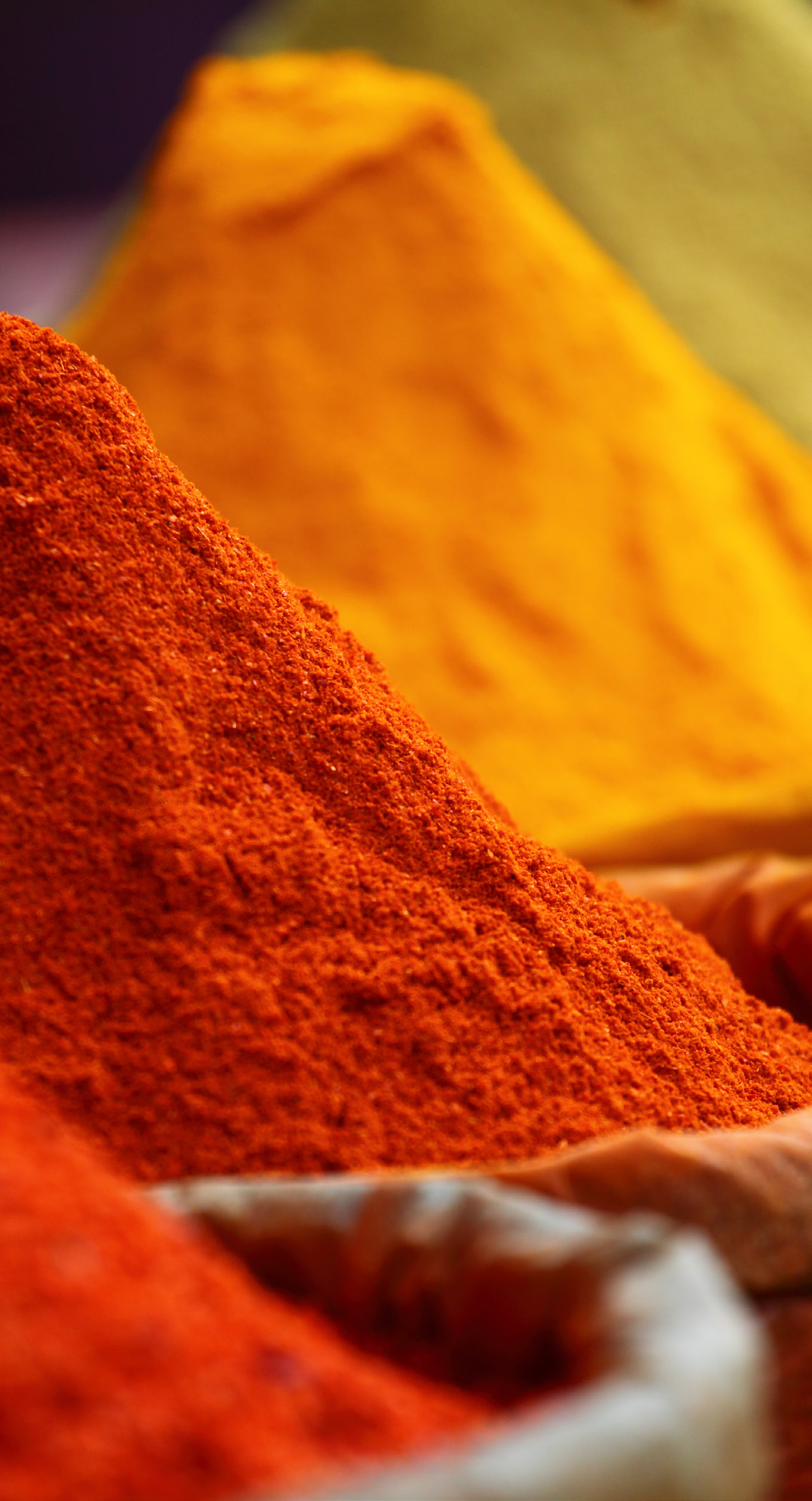 close-up photo of red and yellow spices in a manufacturing setting