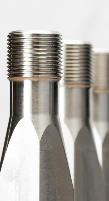 close-up photo of three metal threaded bolts with shadows on a white background