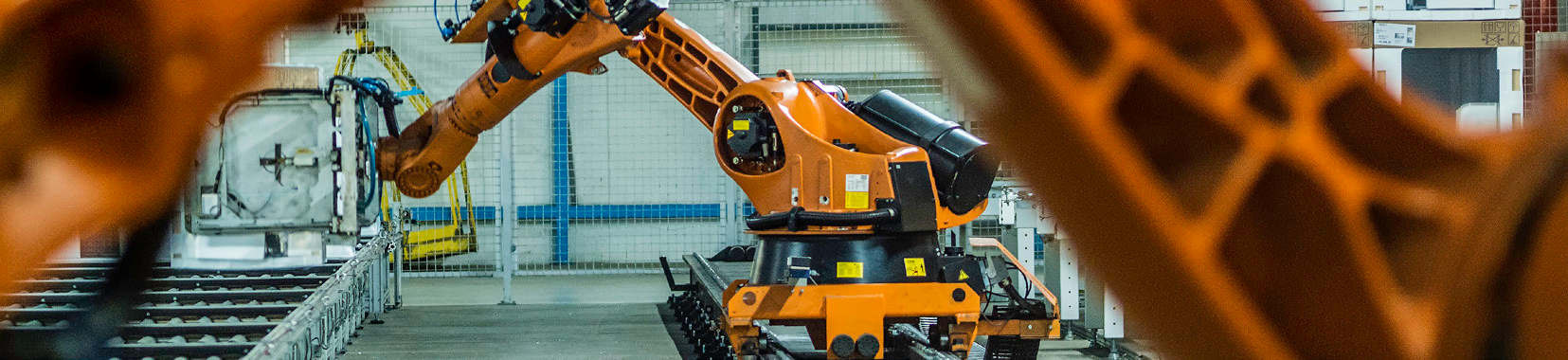 manufacturing facility interior with robotic arm and conveyor system