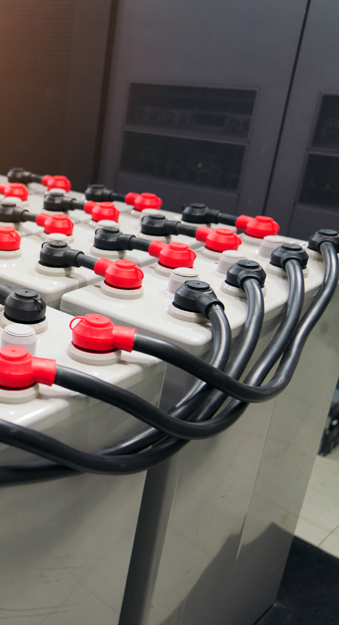 close-up photo of red and black electrical connectors on a gray panel