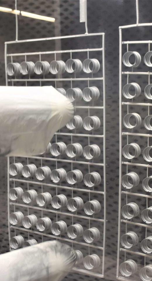 manufacturing facility interior photo showing racks with cylindrical containers