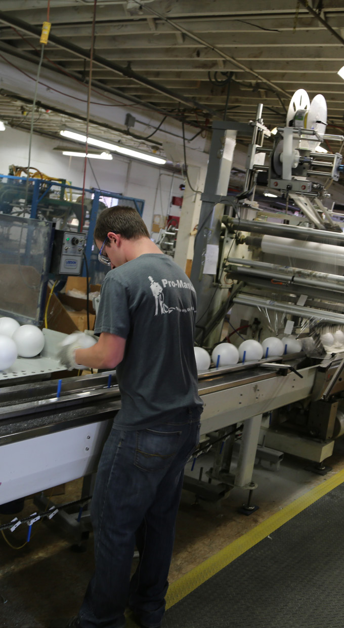 worker operating production line in a manufacturing facility