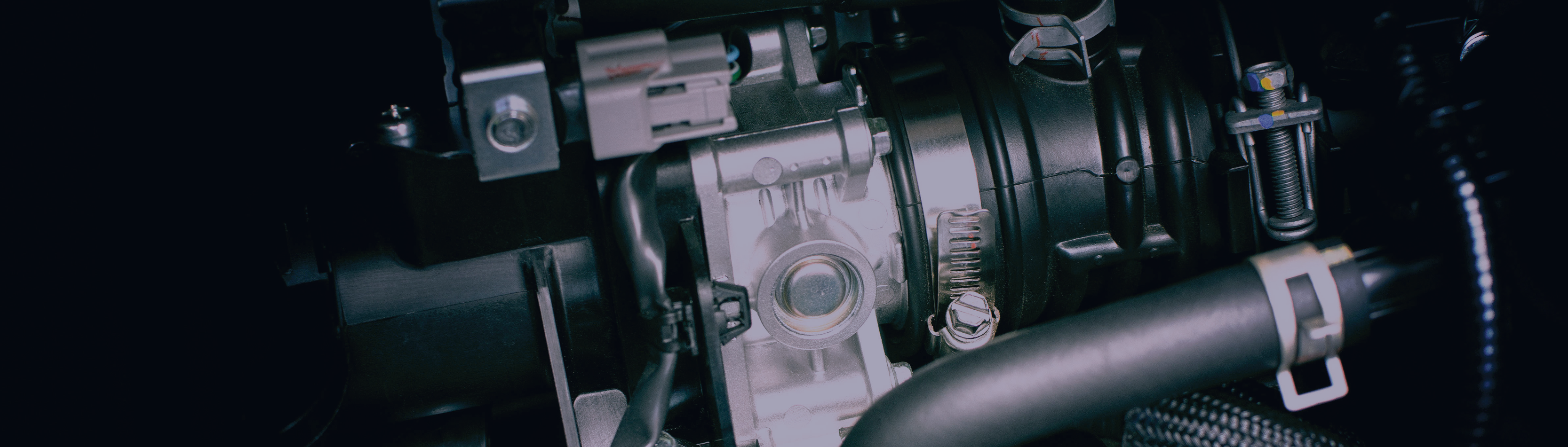 close-up photo of mechanical engine components with dark background