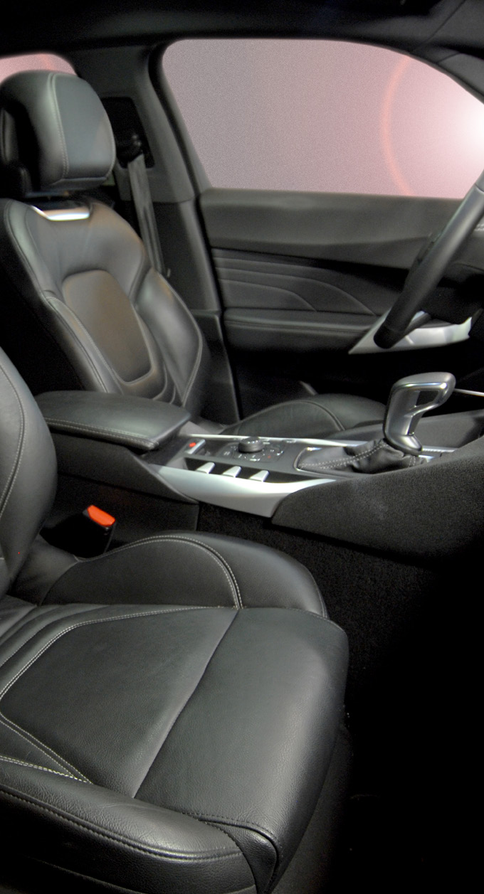 black leather car interior photo showing front seats and center console