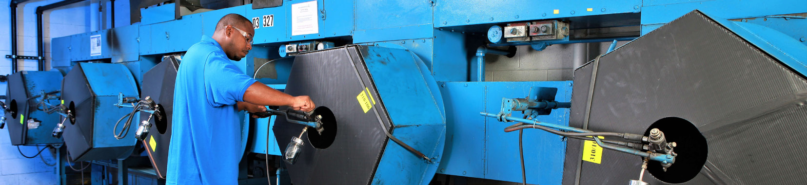worker operating industrial equipment in a manufacturing facility