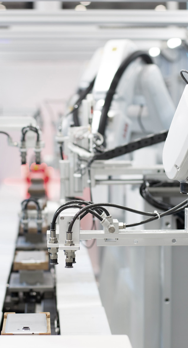 Manufacturing facility interior with automated machinery and conveyor system
