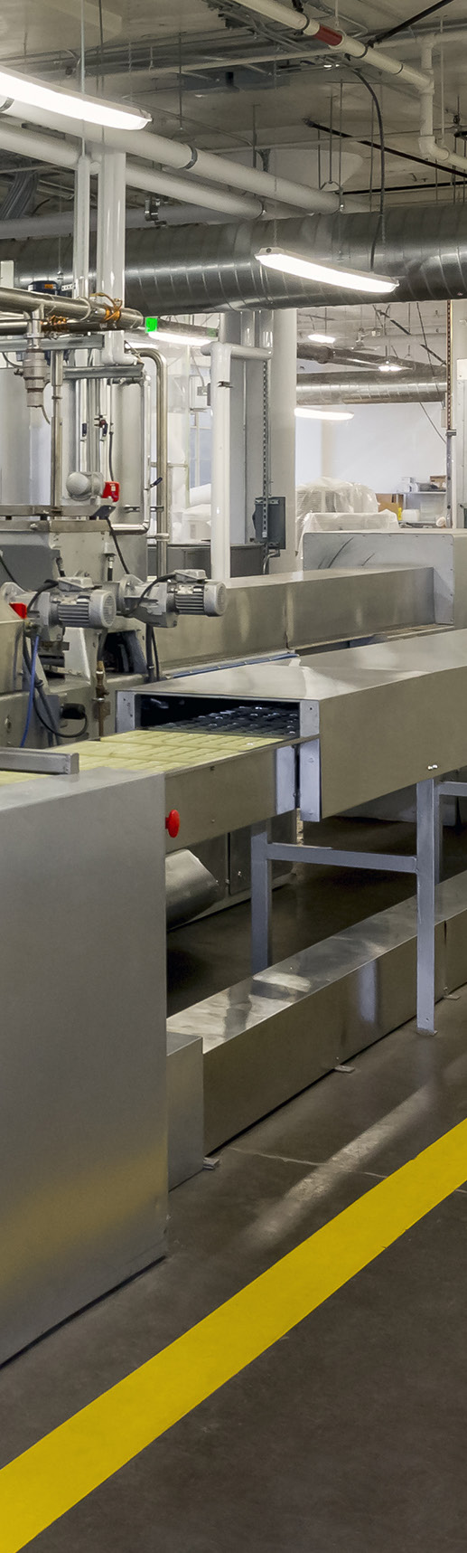 manufacturing facility interior photo with industrial equipment and piping