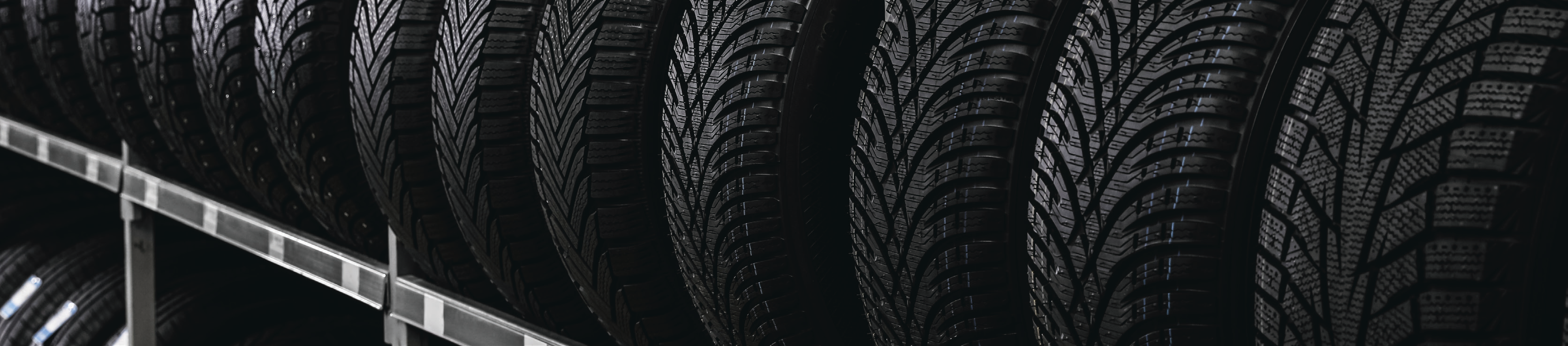 rows of black tires stacked vertically in a factory setting