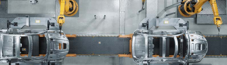 Aerial view of a manufacturing facility with robotic arms and conveyor belts