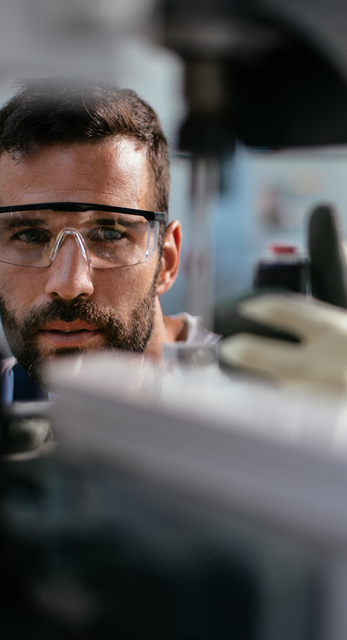 manufacturing facility interior photo with a person operating machinery