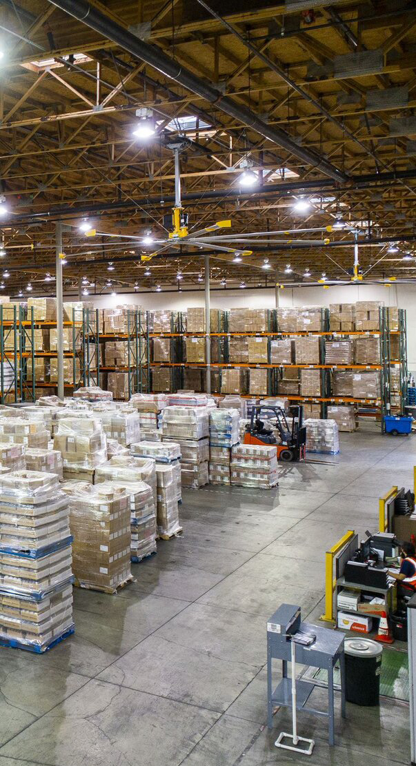 Manufacturing facility interior with stacked pallets and warehouse shelving