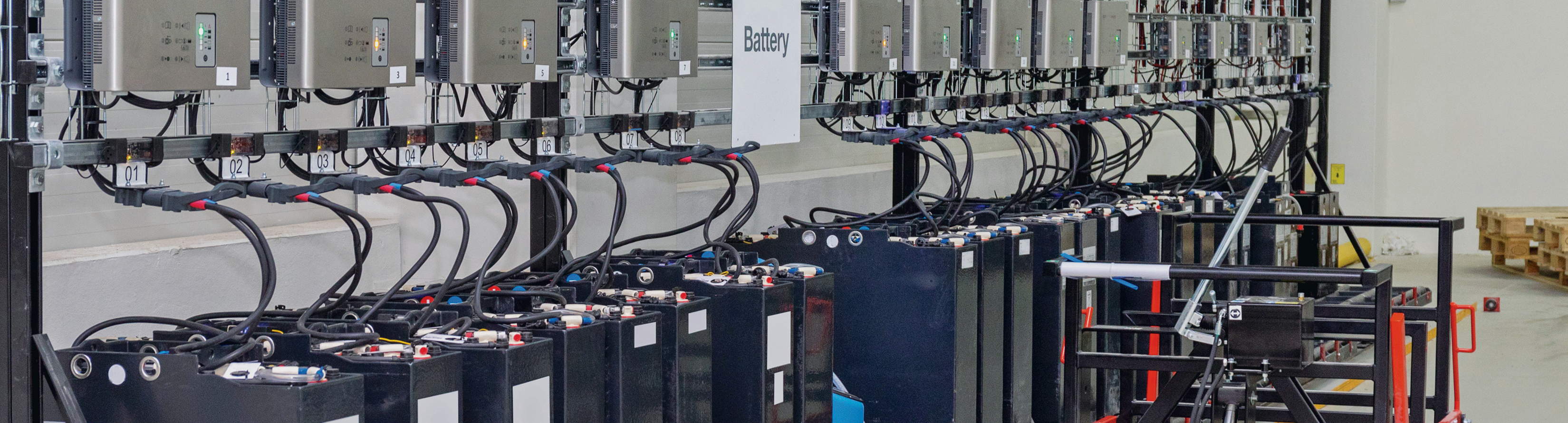 Battery manufacturing facility interior with battery packs and equipment