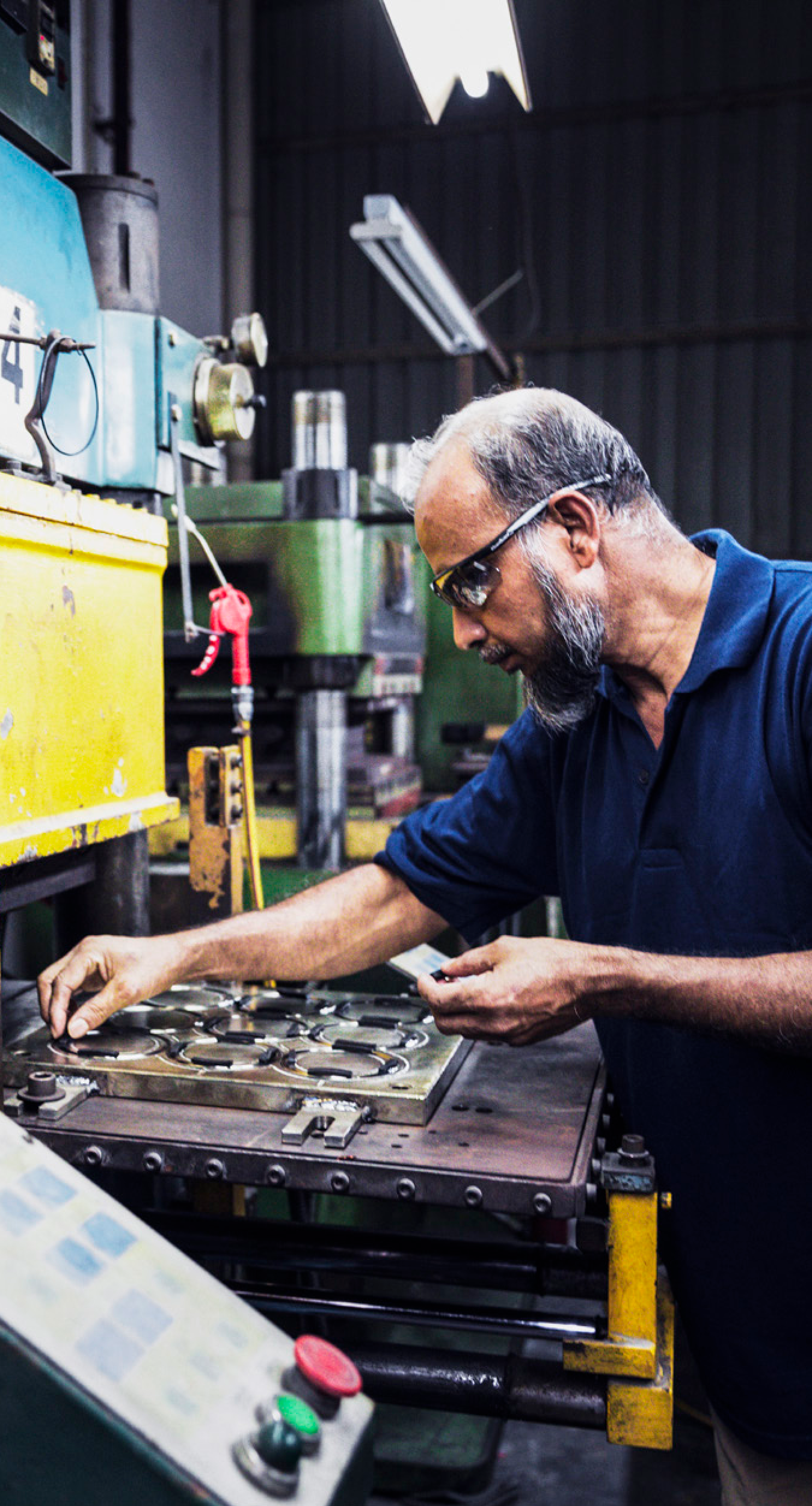 worker operating production line in a manufacturing facility