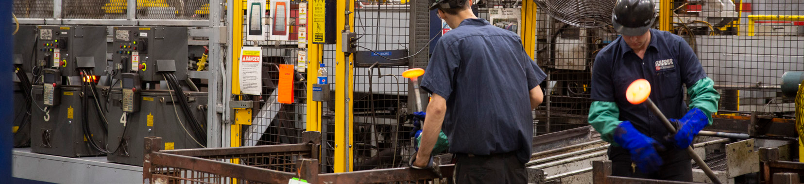 Workers operating production line in a brightly lit manufacturing facility