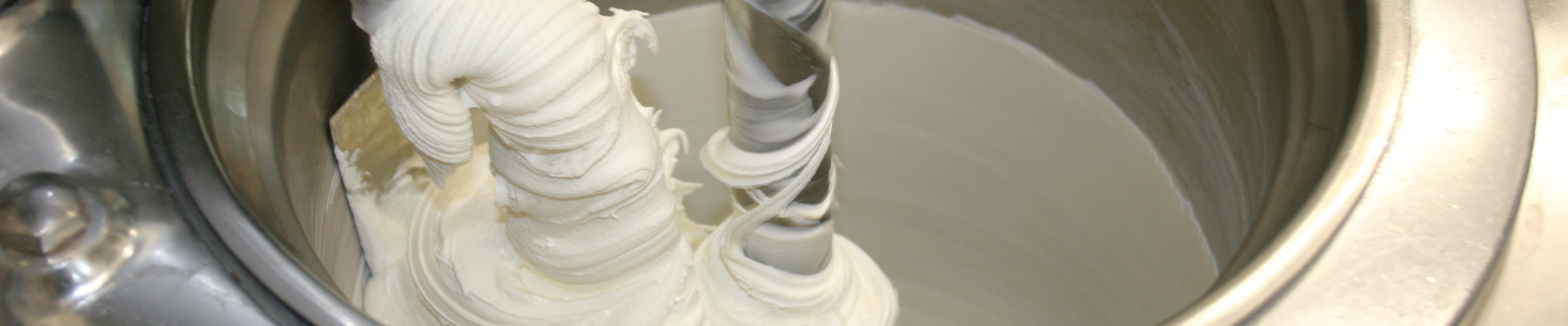 ice cream manufacturing equipment with mixing vat and swirling ice cream inside