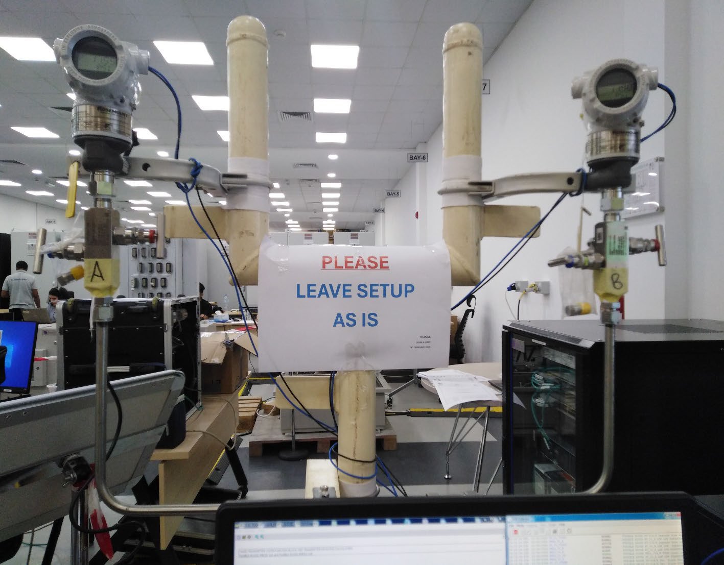 A sign reads "PLEASE LEAVE UP AS IS" taped to machinery