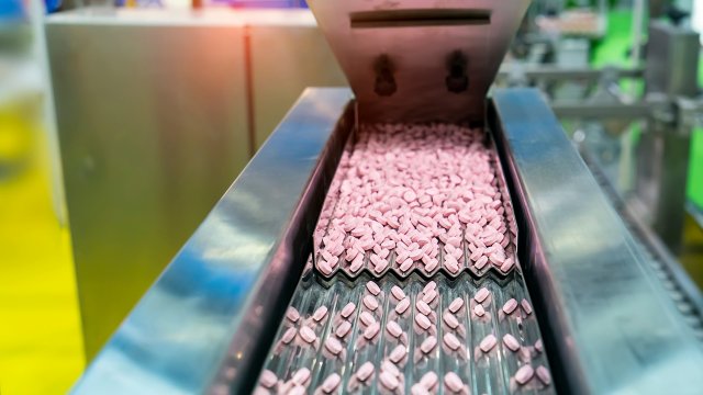 Pills on conveyor in a pharaceutical production plant