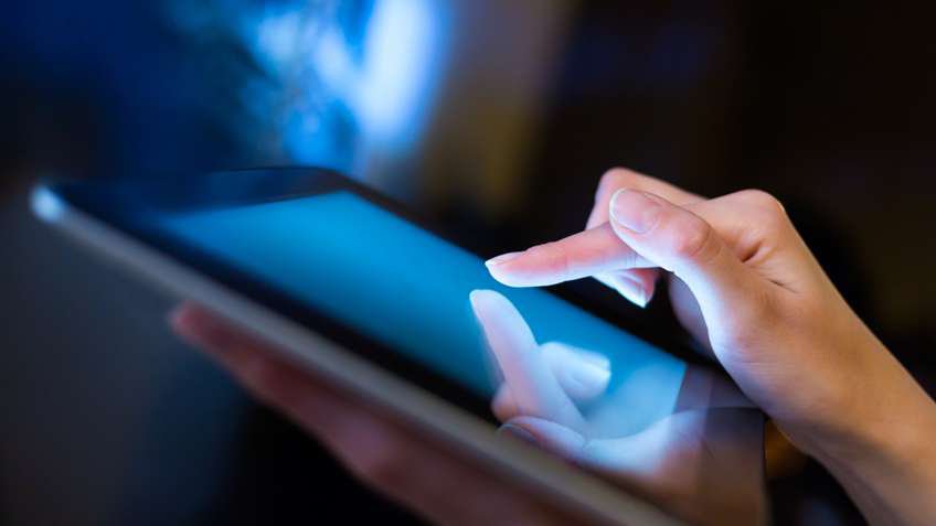 Photograph of person using a mobile tablet