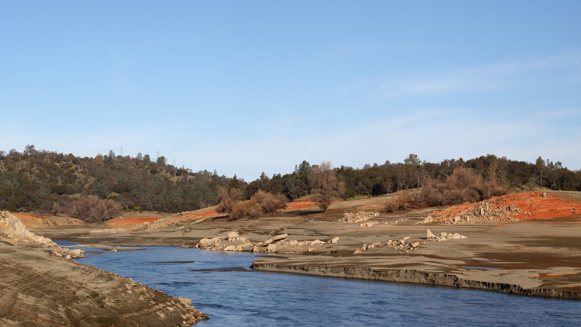 river flowing inside banks red rock