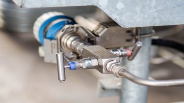Close-up image of a metal pipe equipped with a valve, emphasizing its structure and purpose in plumbing systems.  