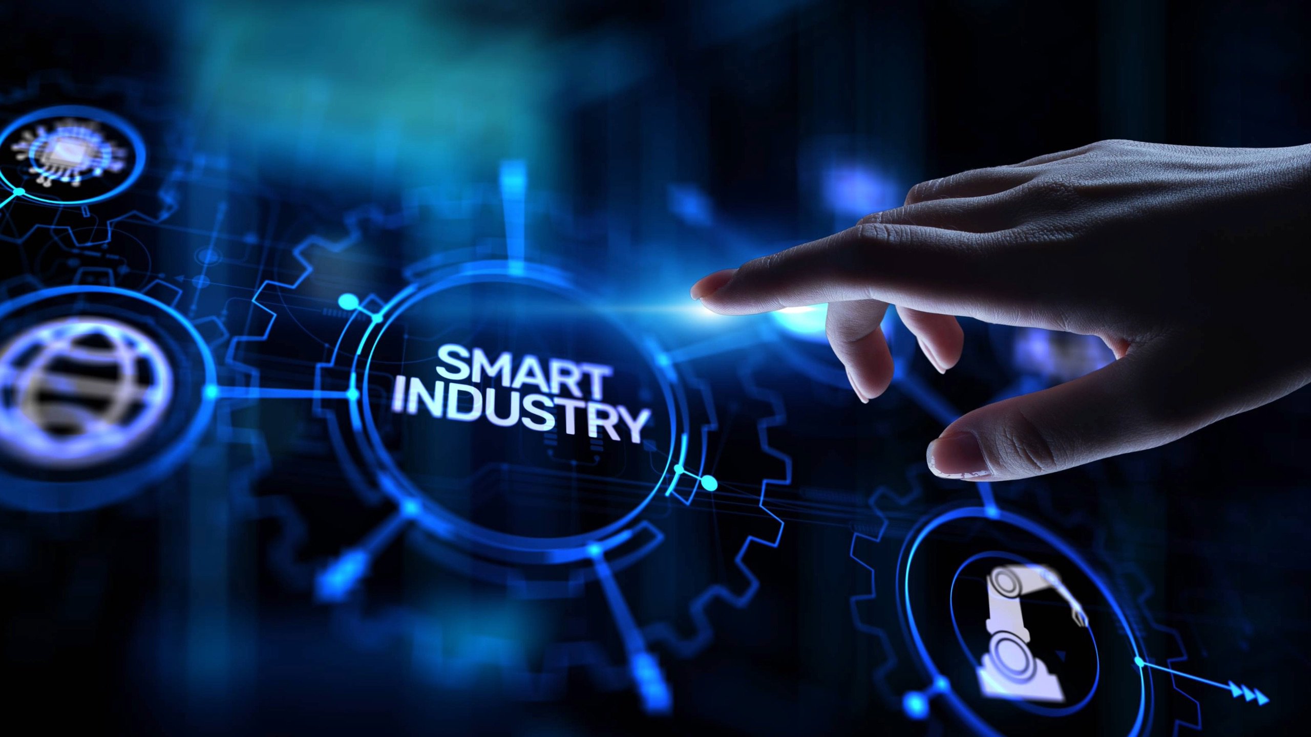 hand touching an electronic button that says "smart industry" and the pushbutton is connected to other technology  logos