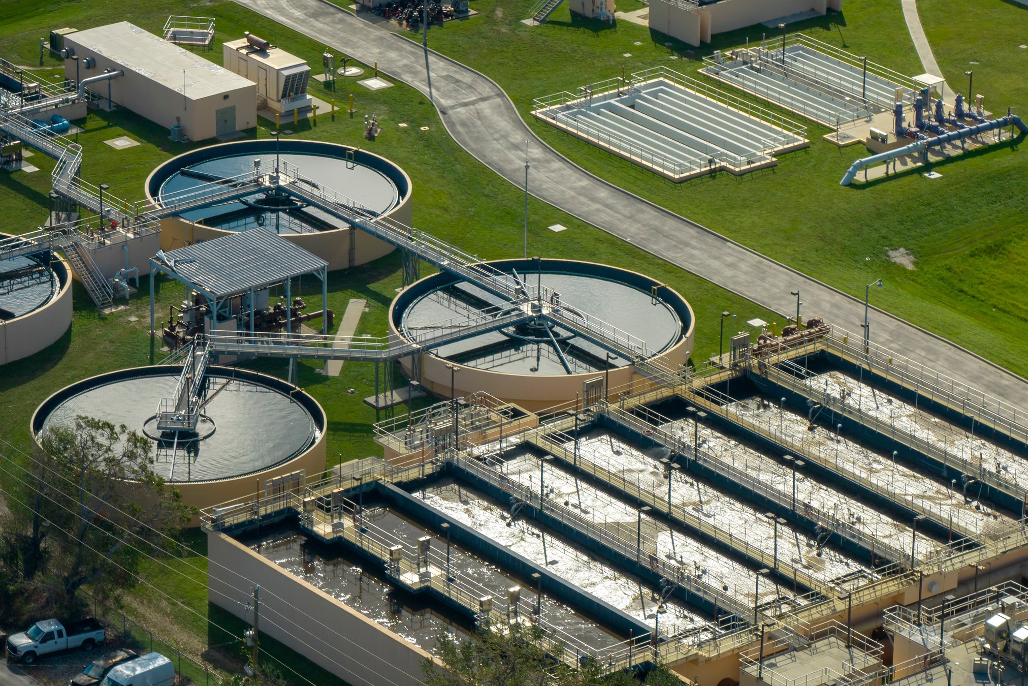 Aerial view of modern water cleaning facility at urban wastewater treatment plant. Purification process of removing undesirable chemicals, suspended solids and gases from contaminated liquid.