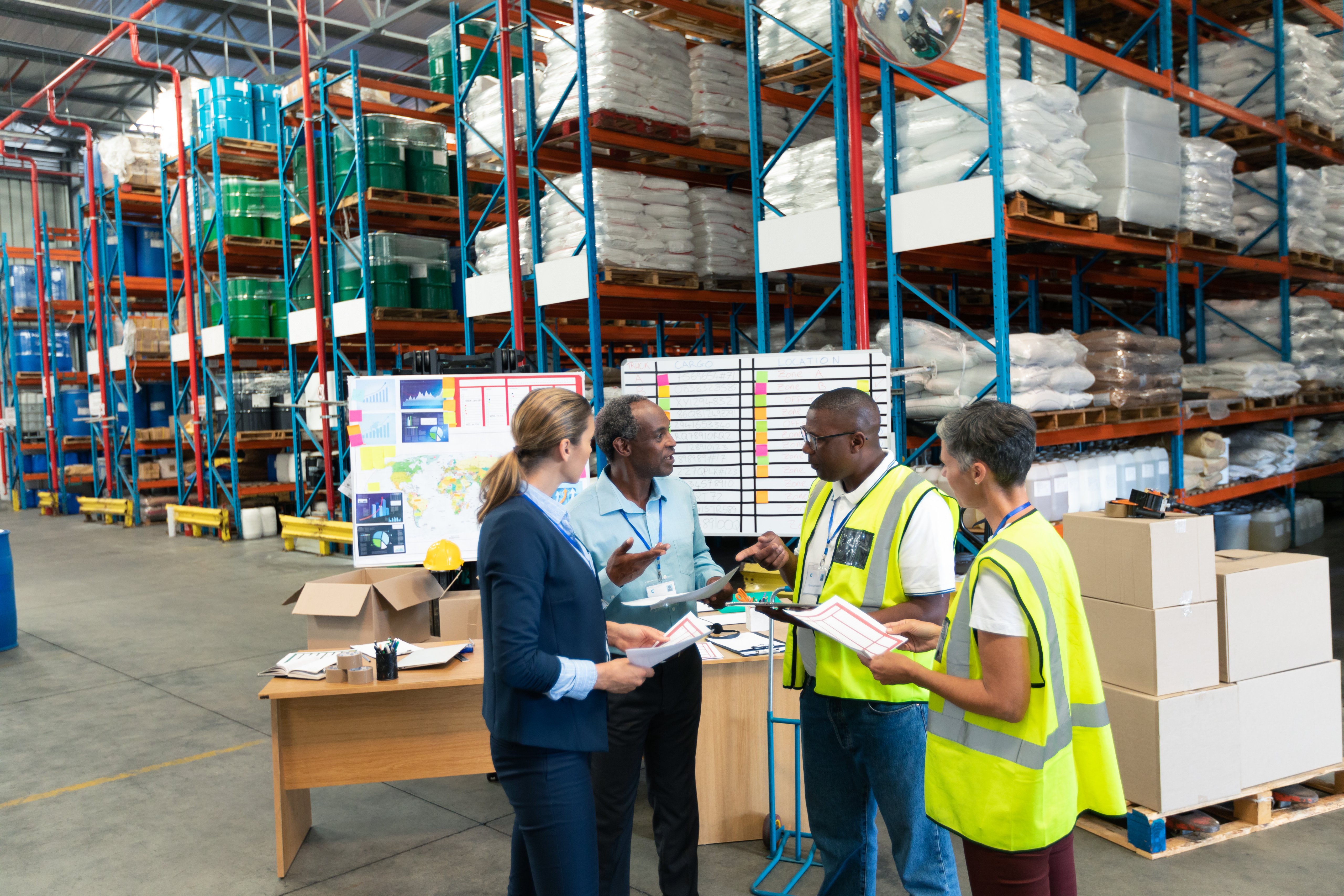 staff discussing together in a warehouse