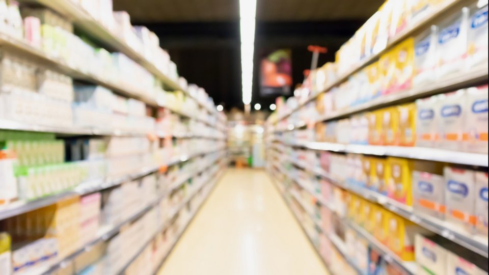 blur supermarket aisle with baby formula milk product on the shelf