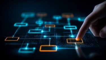 Finger selecting connected workflow blocks on a digital diagram representing process automation and system orchestration.