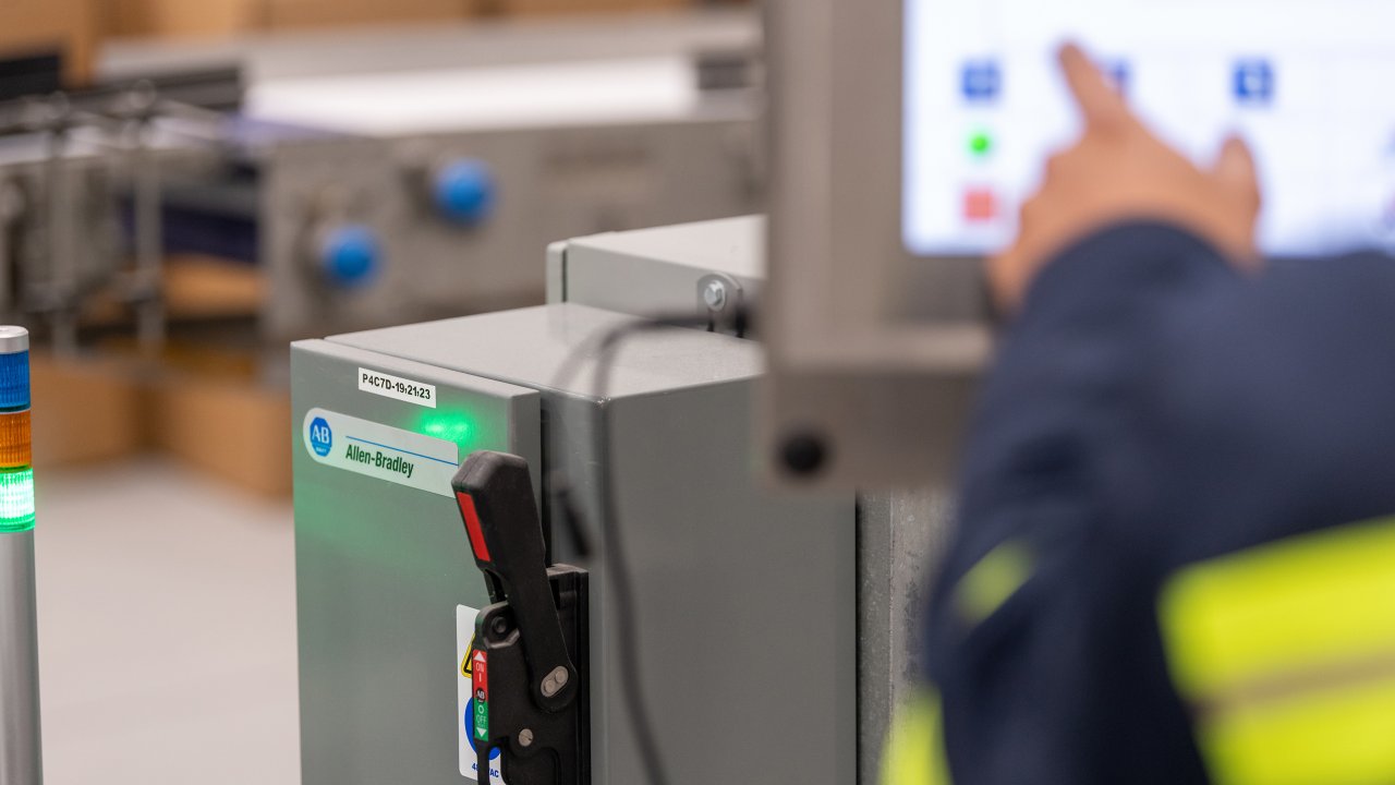 An Allen-Bradley controller is shown with a technician's hand pointing at the human machine interface. Rockwell Automation provides product and application technical support for Allen-Bradley products.Great Lakes Cheese factory on Thursday, May 27, 2021 in Hiram, OH
