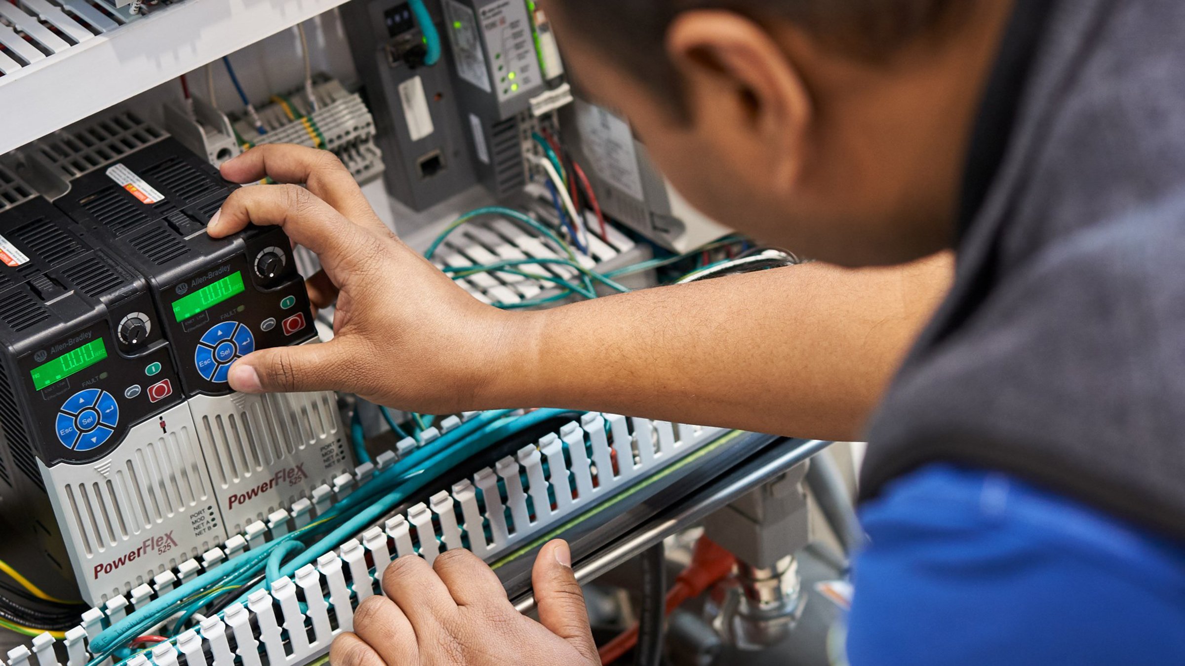 Technician working on PowerFlex525 in cabinet