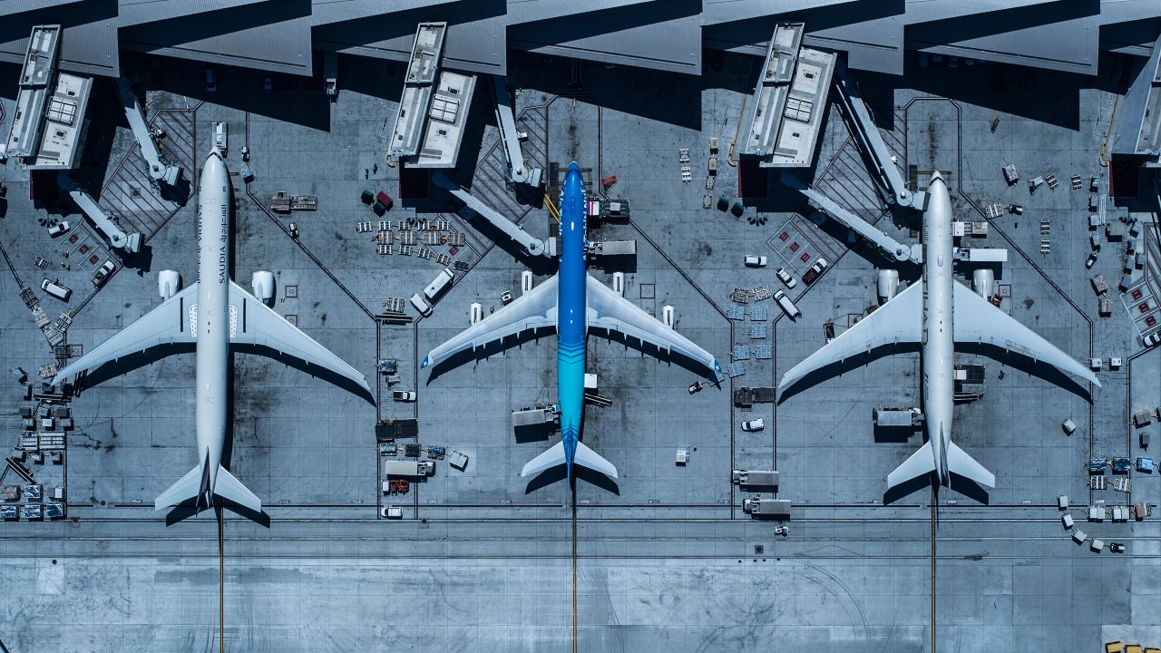 Overhead shot of three jets parked at airport terminal