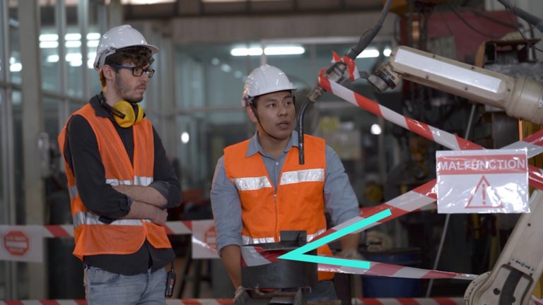 two male workers in a factory