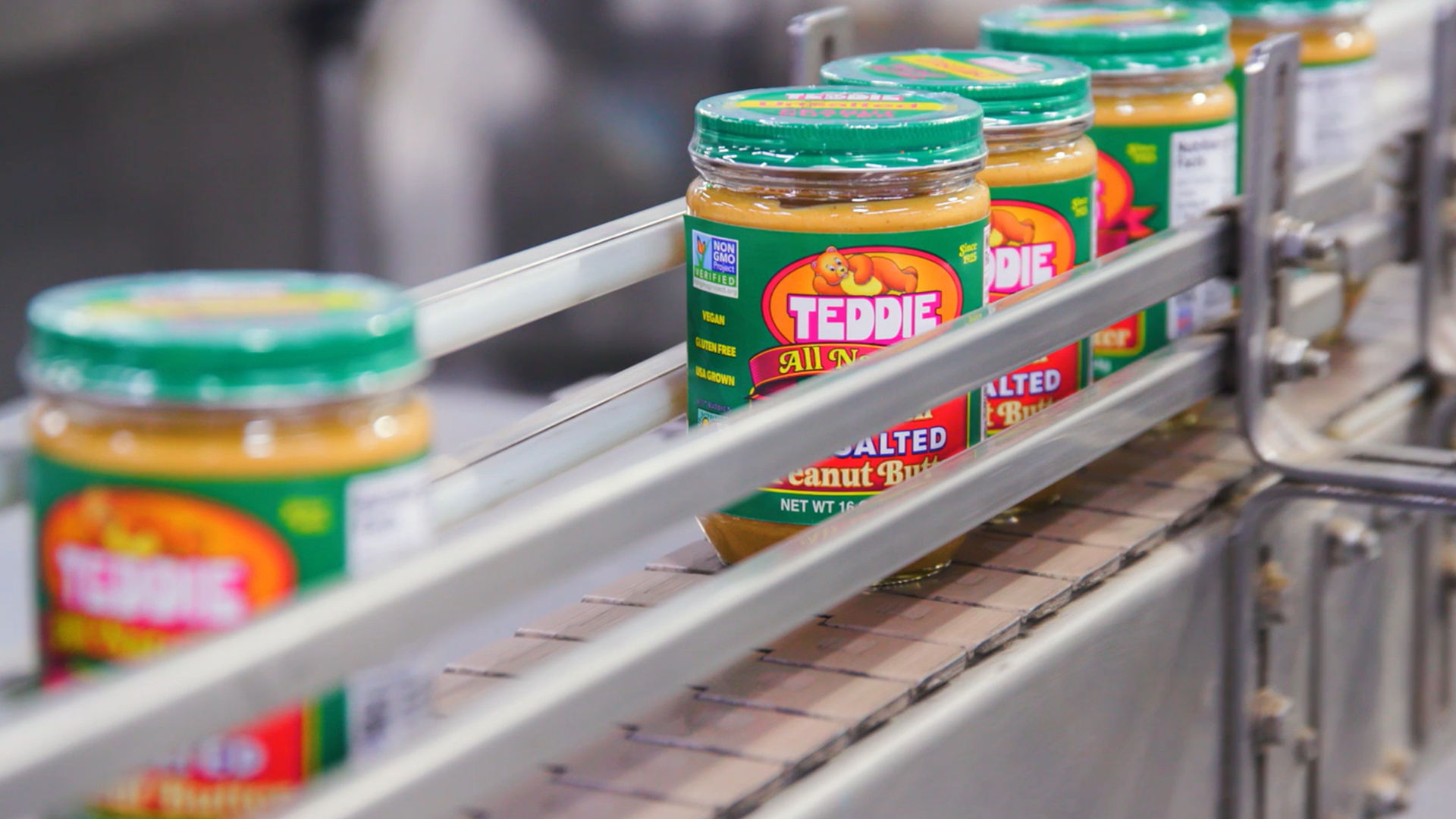 Teddie Peanut Butter jars on a production conveyor belt