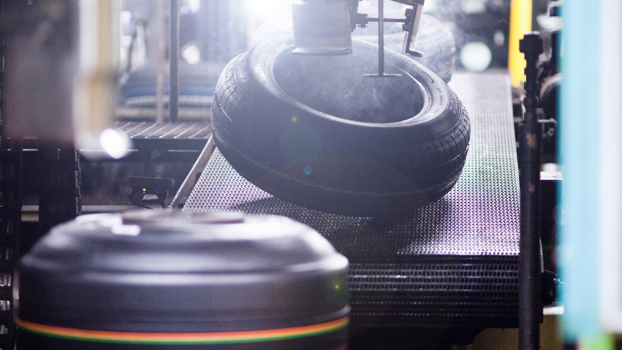 Tire in production moving down a conveyor