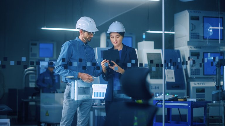 Modern Factory: Female Project Manager, Male Engineer Standing in High Tech Development Facility, Talking and Using Tablet Computer. Contemporary Facility
