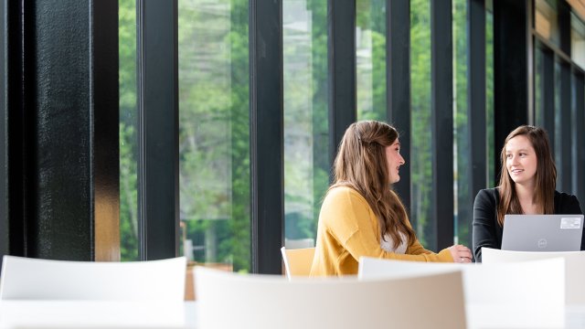 Two women having a conversation at a table in from of a windowo at Great Lakes Cheese Headquarters on Wednesday, May 26, 2021 in Hiram, OH